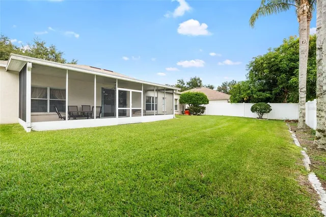 a view of backyard with swimming pool and seating space
