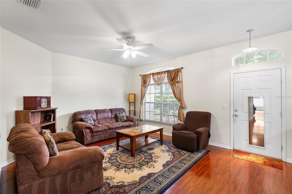2763 Valencia Grove Drive Valrico, FL 33596 - Photo 5 of 38 a living room with furniture ceiling fan and a window