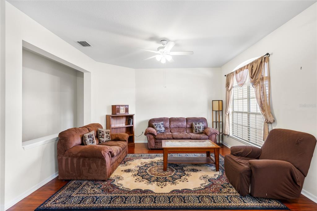 2763 Valencia Grove Drive Valrico, FL 33596 - Photo 7 of 38 a living room with furniture or couch and a window