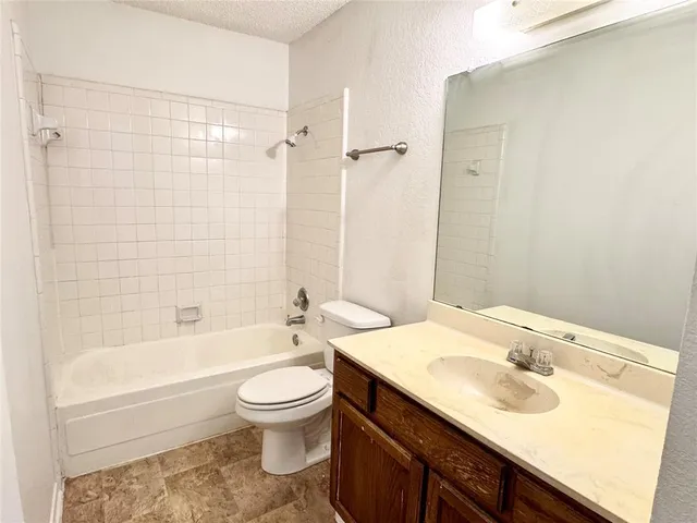 a bathroom with a sink toilet vanity and shower