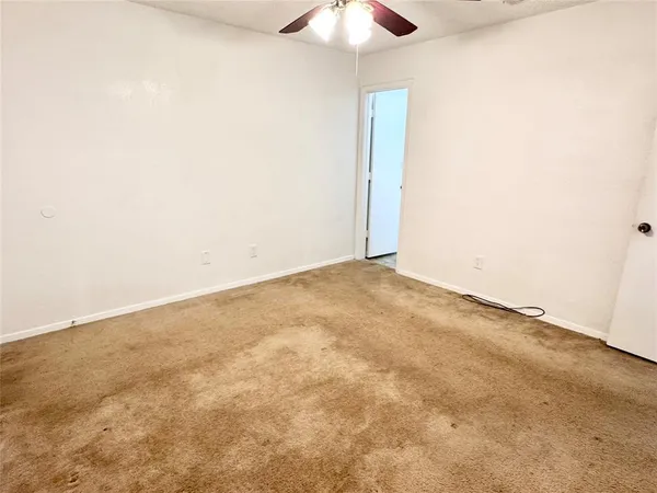 an empty room with a ceiling fan