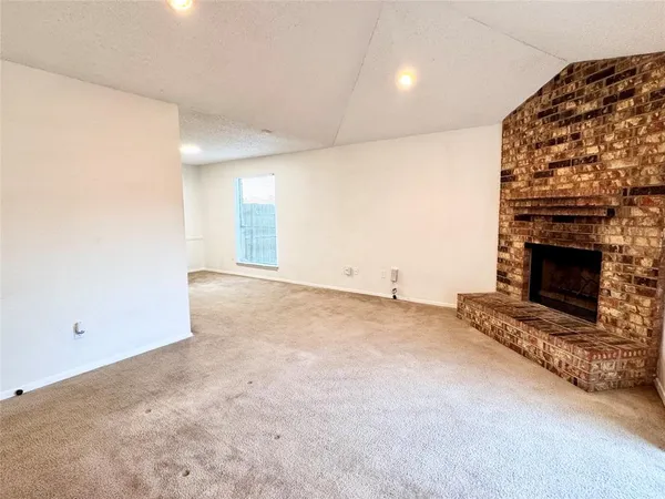 an empty room with a fireplace and painted walls