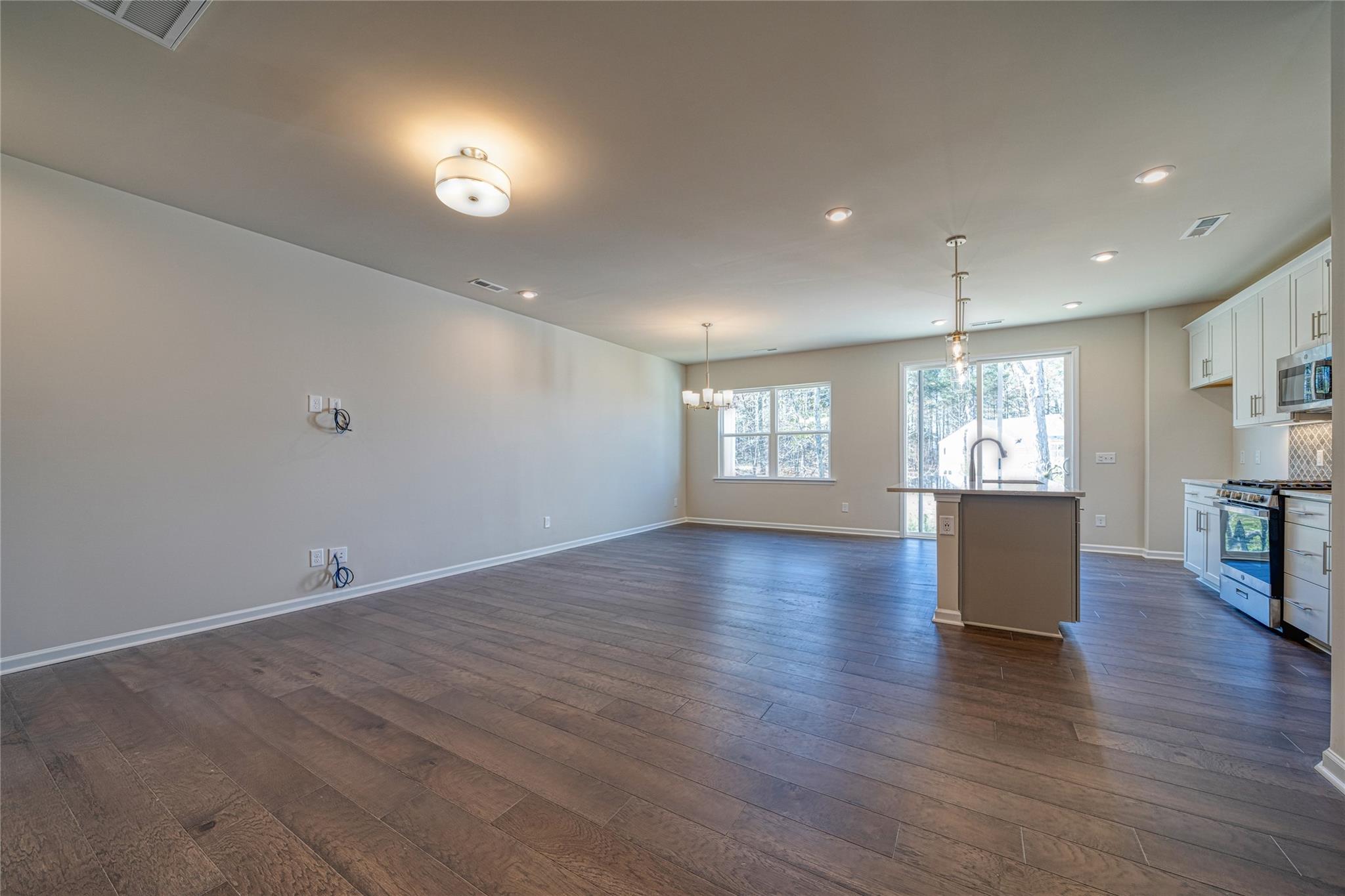 513 Madison Falls Court Fort Mill, SC 29708 - Photo 13 of 37 an empty room with wooden floor and windows