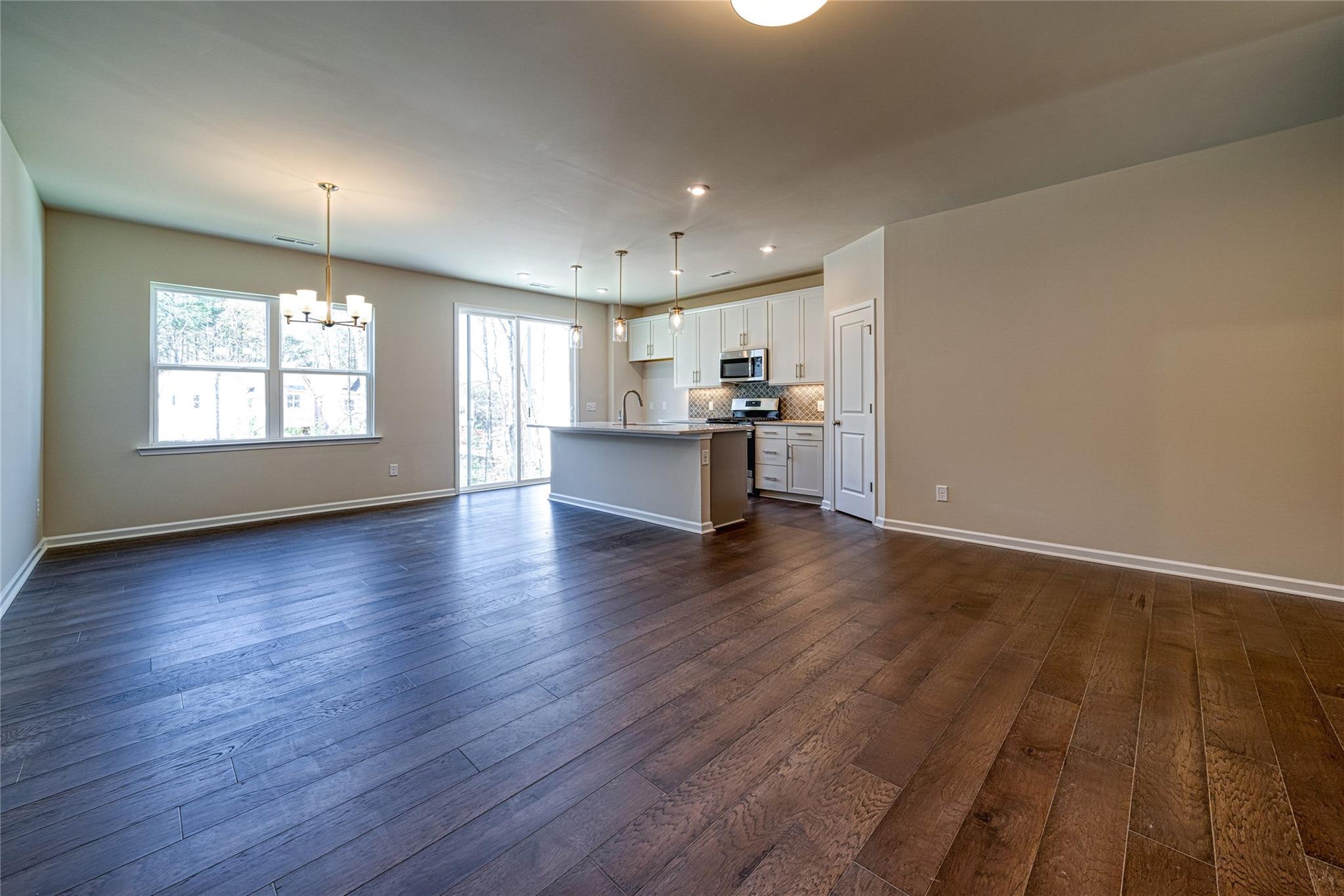513 Madison Falls Court Fort Mill, SC 29708 - Photo 14 of 37 an empty room with wooden floor and windows