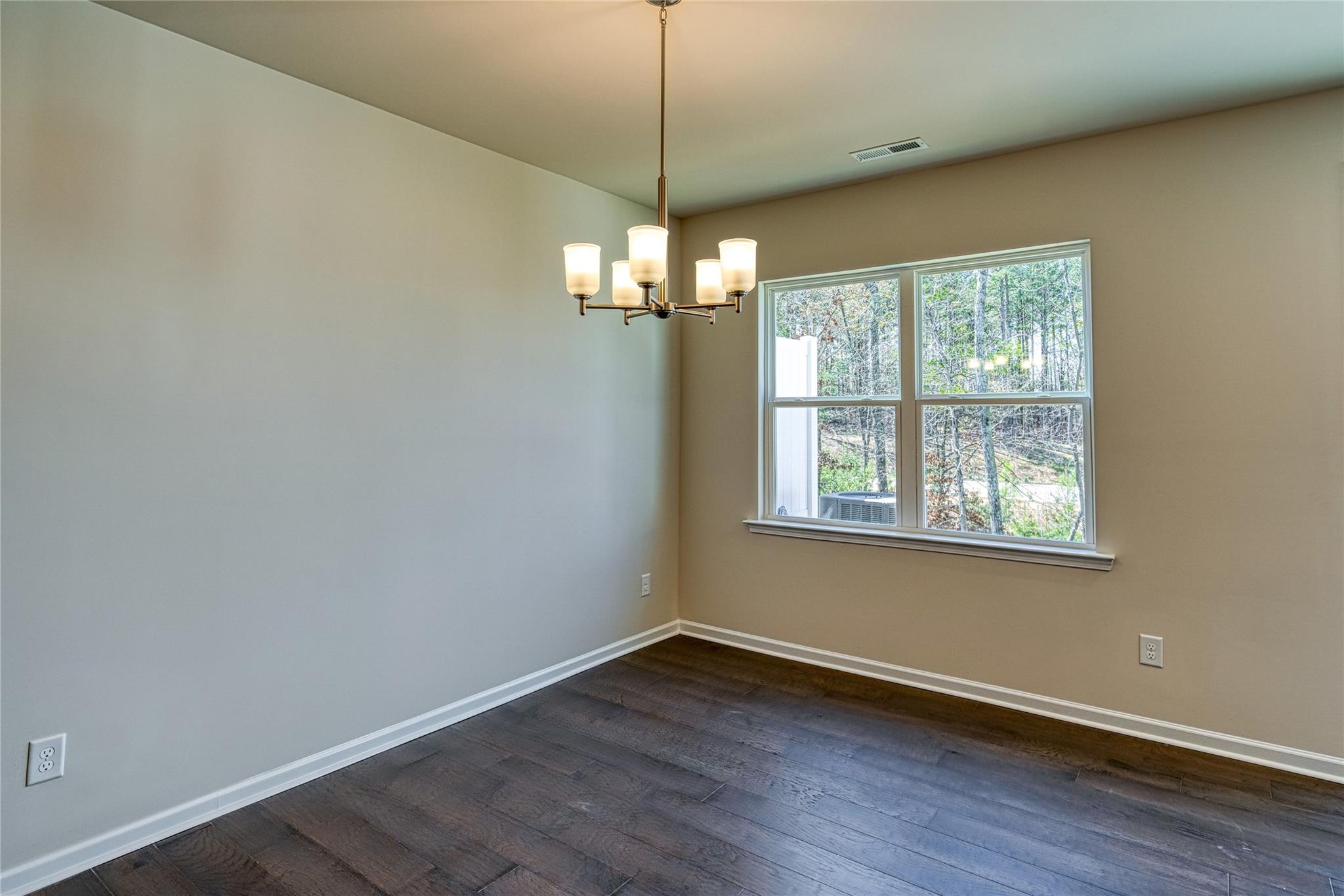 513 Madison Falls Court Fort Mill, SC 29708 - Photo 15 of 37 a view of a room with wooden floor chandelier and window