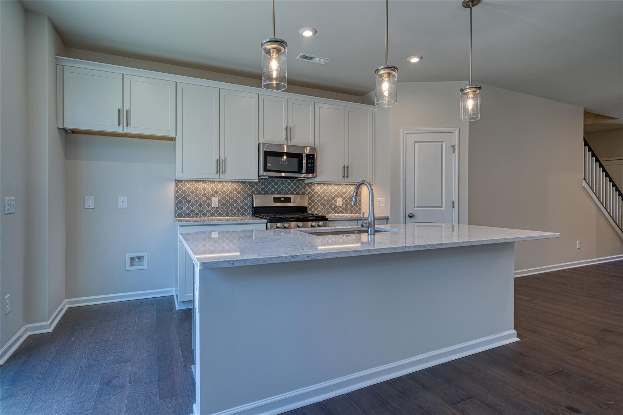 513 Madison Falls Court Fort Mill, SC 29708 - Photo 16 of 37 a kitchen with kitchen island granite countertop a sink a counter space appliances and cabinets