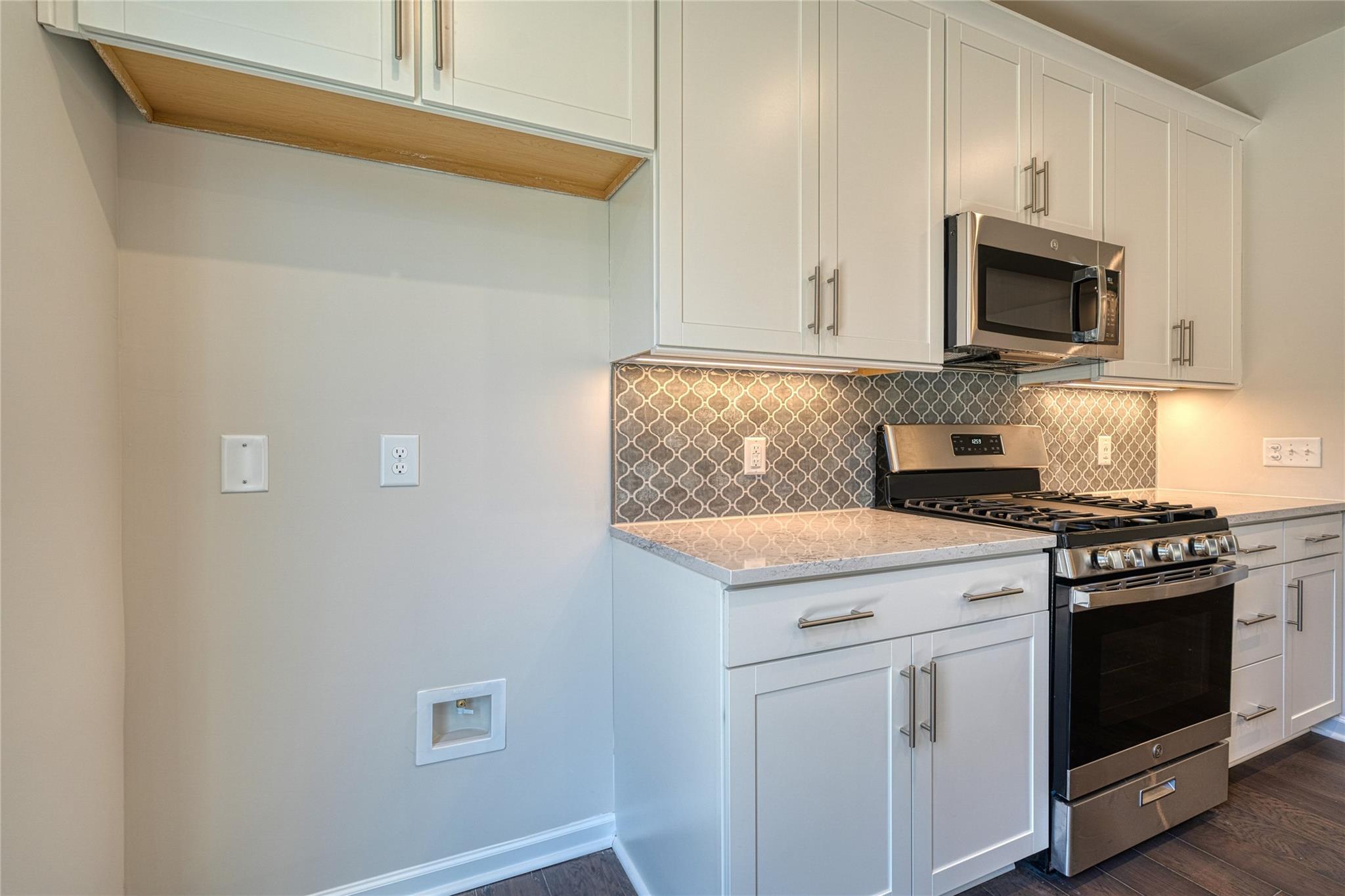 513 Madison Falls Court Fort Mill, SC 29708 - Photo 17 of 37 a kitchen with stainless steel appliances white cabinets and a stove top oven