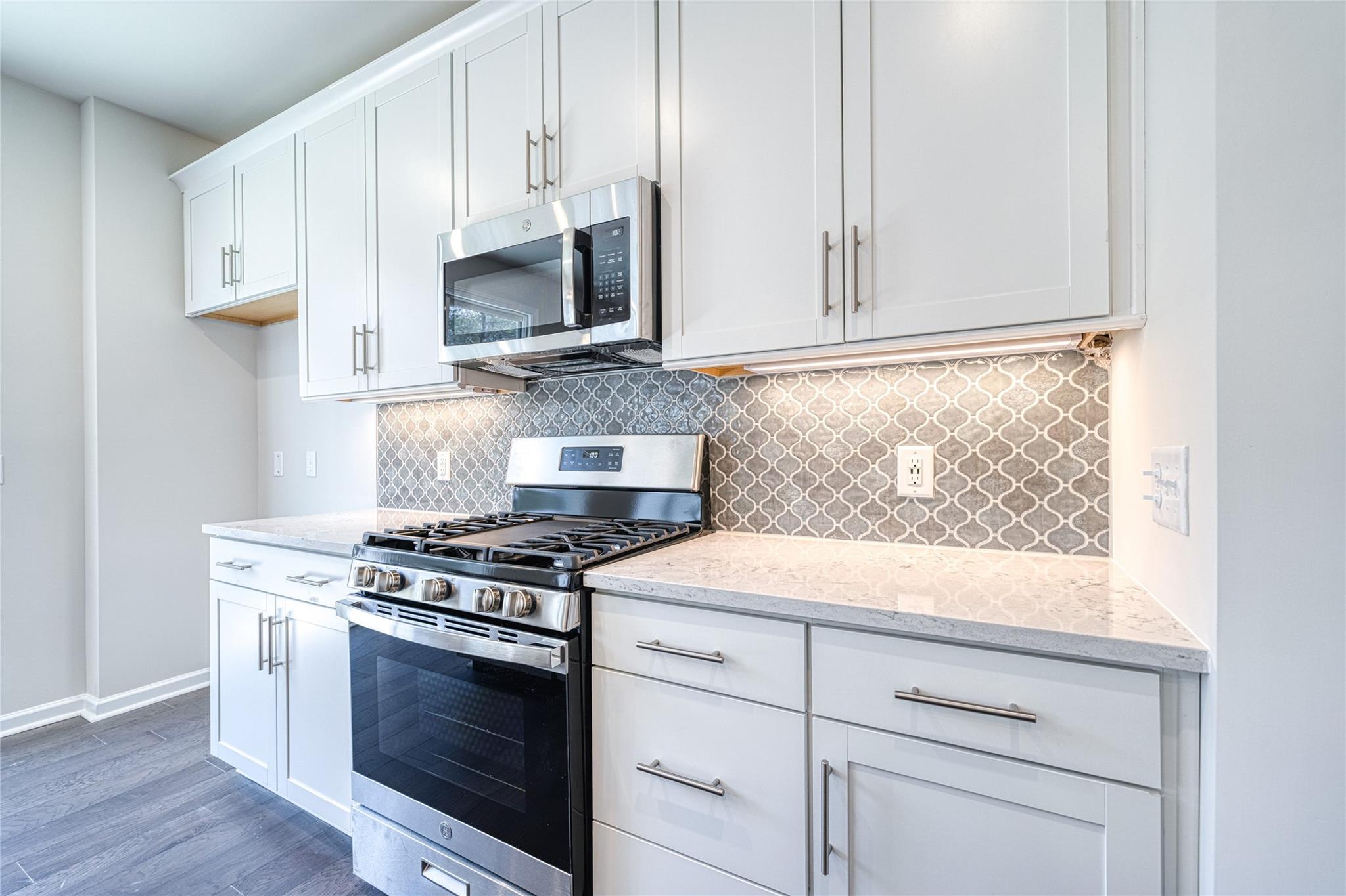 513 Madison Falls Court Fort Mill, SC 29708 - Photo 20 of 37 a kitchen with white cabinets and appliances