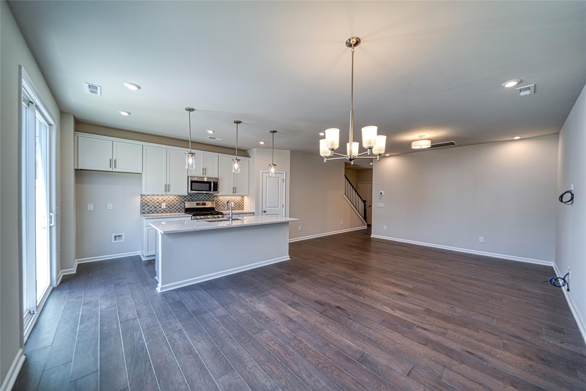 513 Madison Falls Court Fort Mill, SC 29708 - Photo 2 of 37 a view of a kitchen with stove and wooden floor