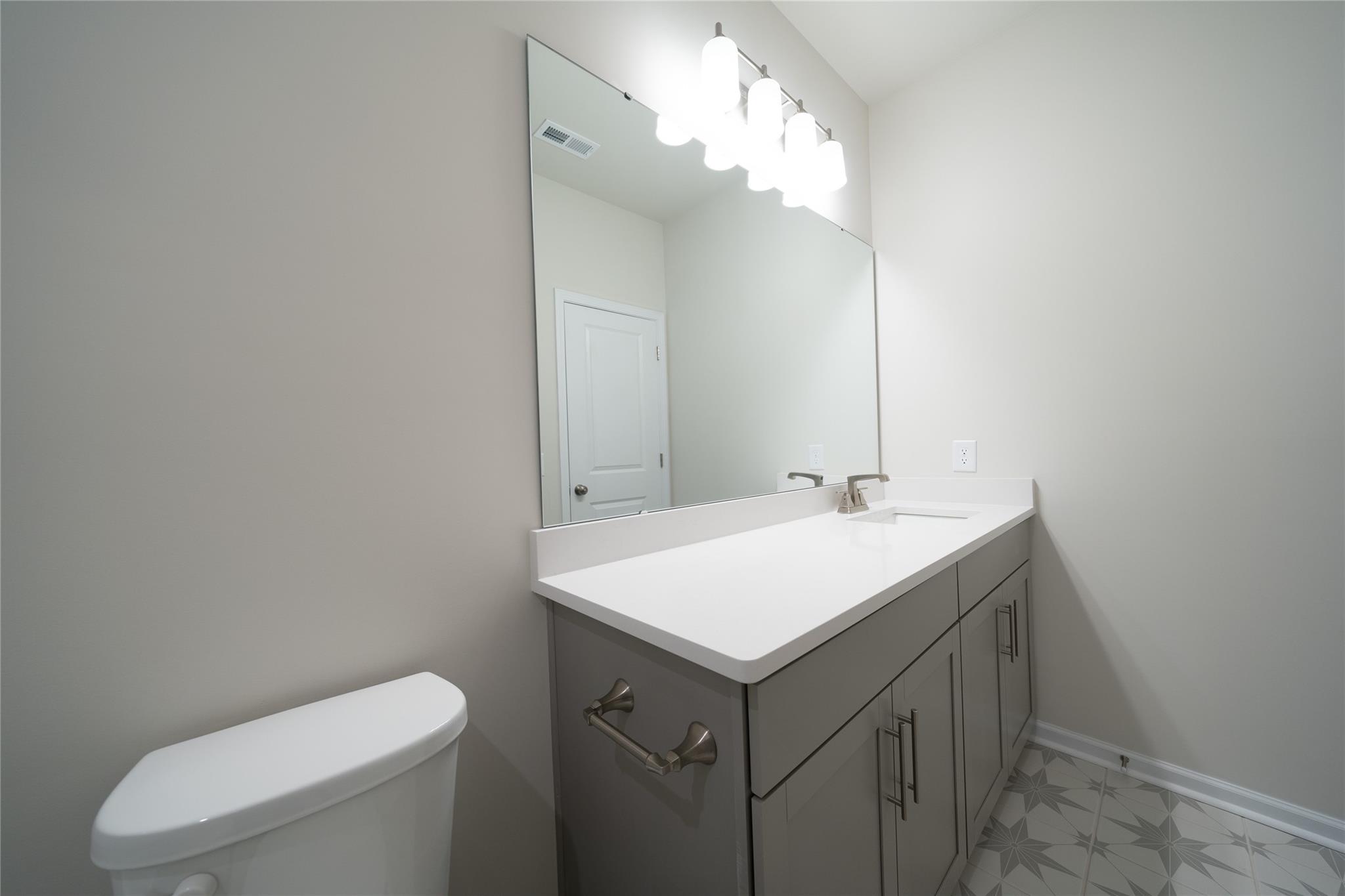 513 Madison Falls Court Fort Mill, SC 29708 - Photo 29 of 37 a bathroom with a sink a toilet and a mirror