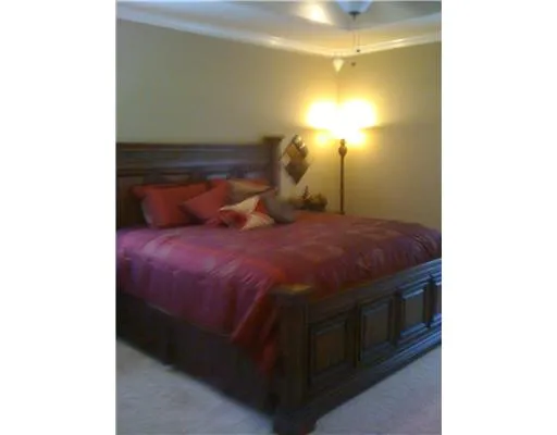 a bed sitting in a bedroom next to a bathroom