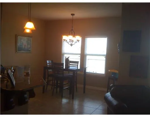 a view of a dining room with furniture and window