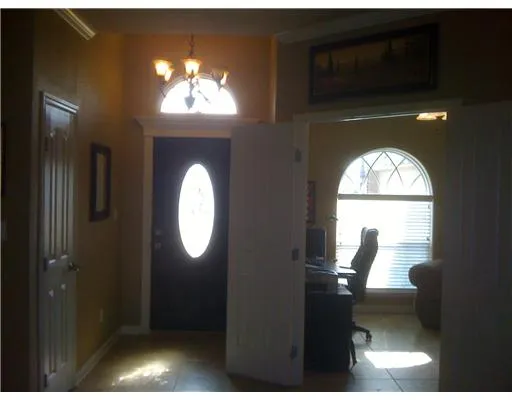 a view of a livingroom with furniture mirror and window