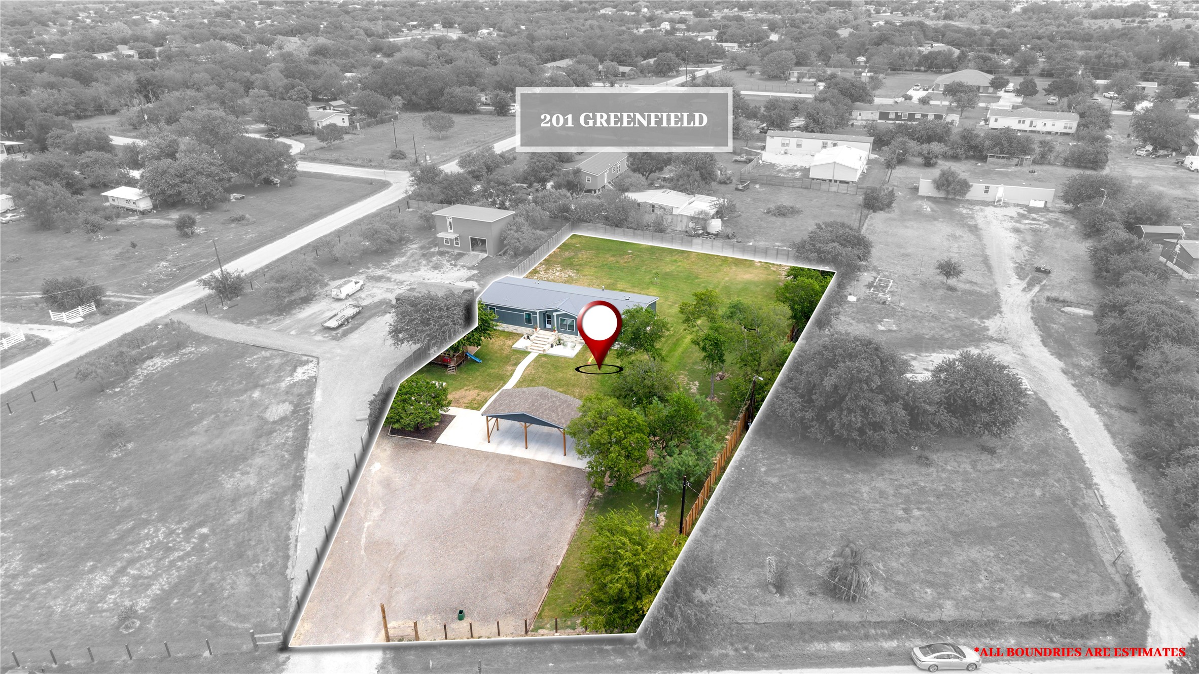 201 Greenfield Road Kyle, TX 78640 - Photo 3 of 28 An overhead perspective reveals the property's generous acreage, bordered by natural landscaping and featuring a covered parking structure.