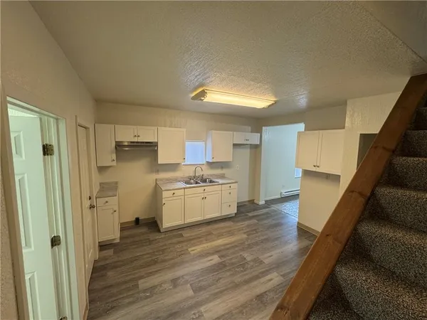a kitchen with stainless steel appliances a refrigerator and a stove top oven