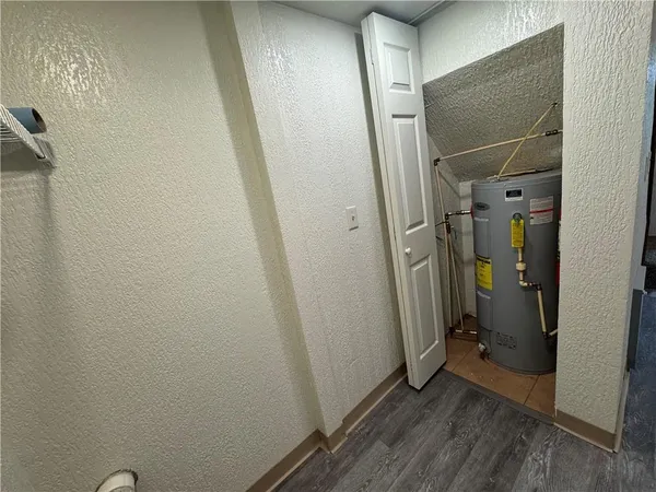 a view of a hallway with wooden floor and a hallway