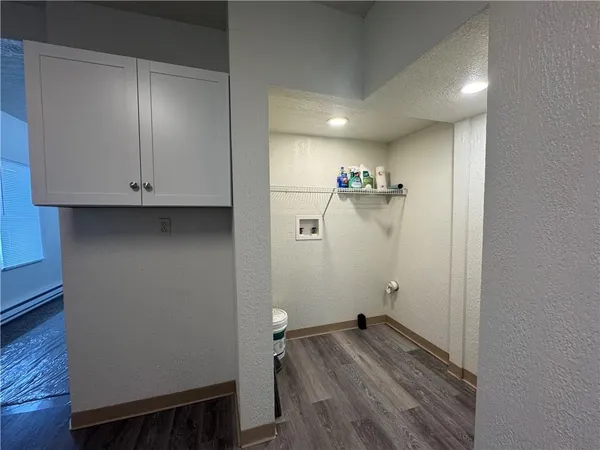 a view of walk in closet with wooden floor