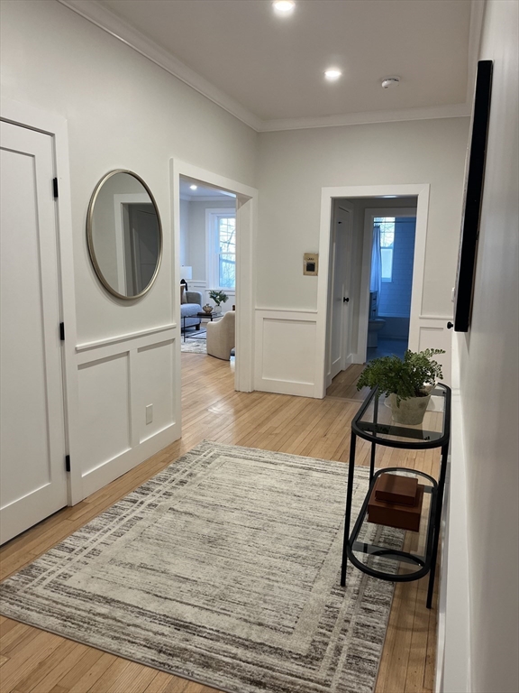 108 St Paul Street, Unit 2 Brookline, MA 02446 - Photo 11 of 15 a view of a hallway with furniture and wooden floor