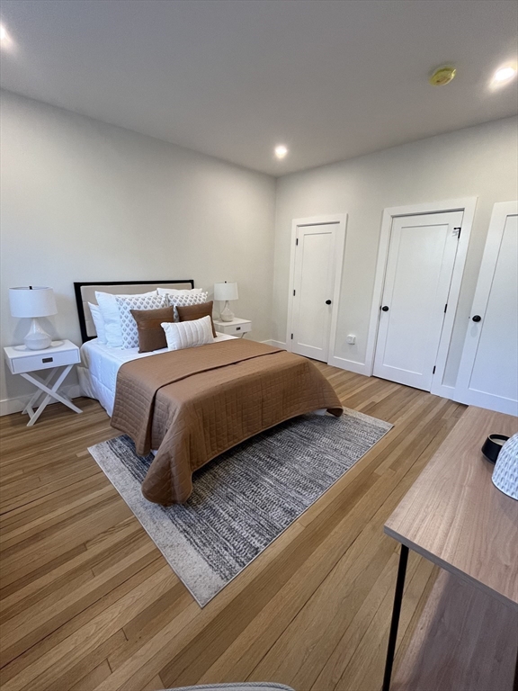 108 St Paul Street, Unit 2 Brookline, MA 02446 - Photo 13 of 15 a bedroom with a bed and wooden floor