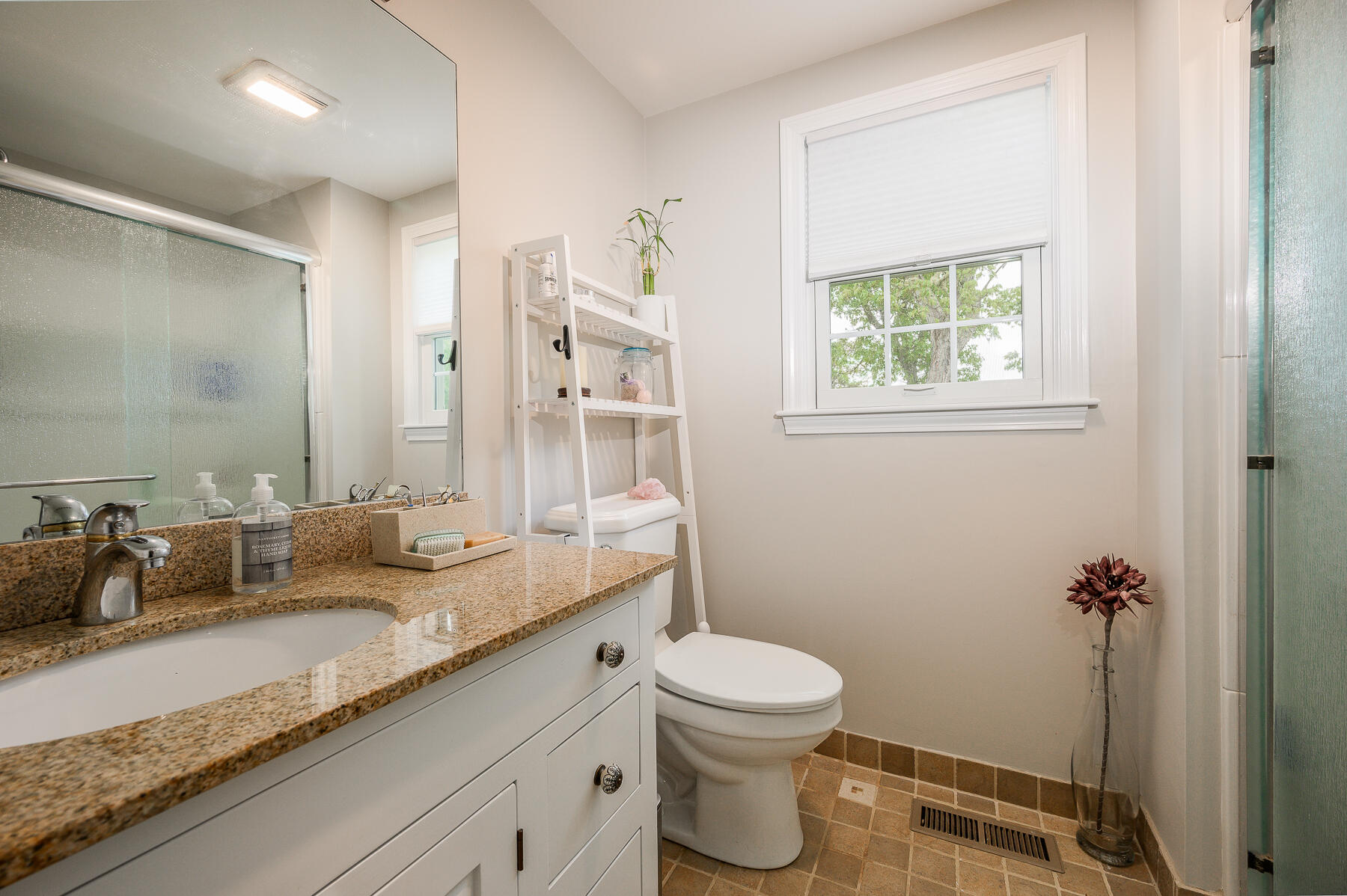 20 Squirrel Run Eastham, MA 02642 - Photo 19 of 37 a bathroom with a granite countertop sink a toilet and a mirror