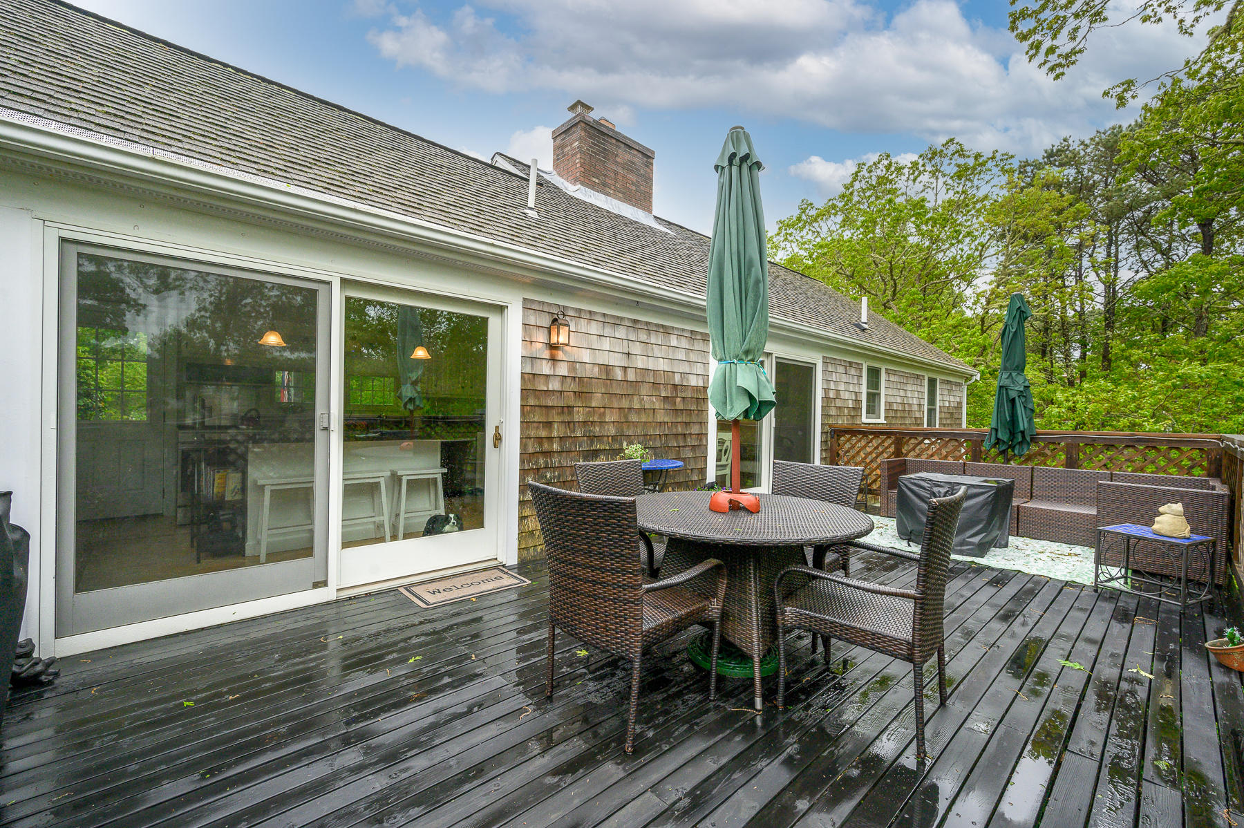 20 Squirrel Run Eastham, MA 02642 - Photo 32 of 37 a patio with table and chairs and potted plants