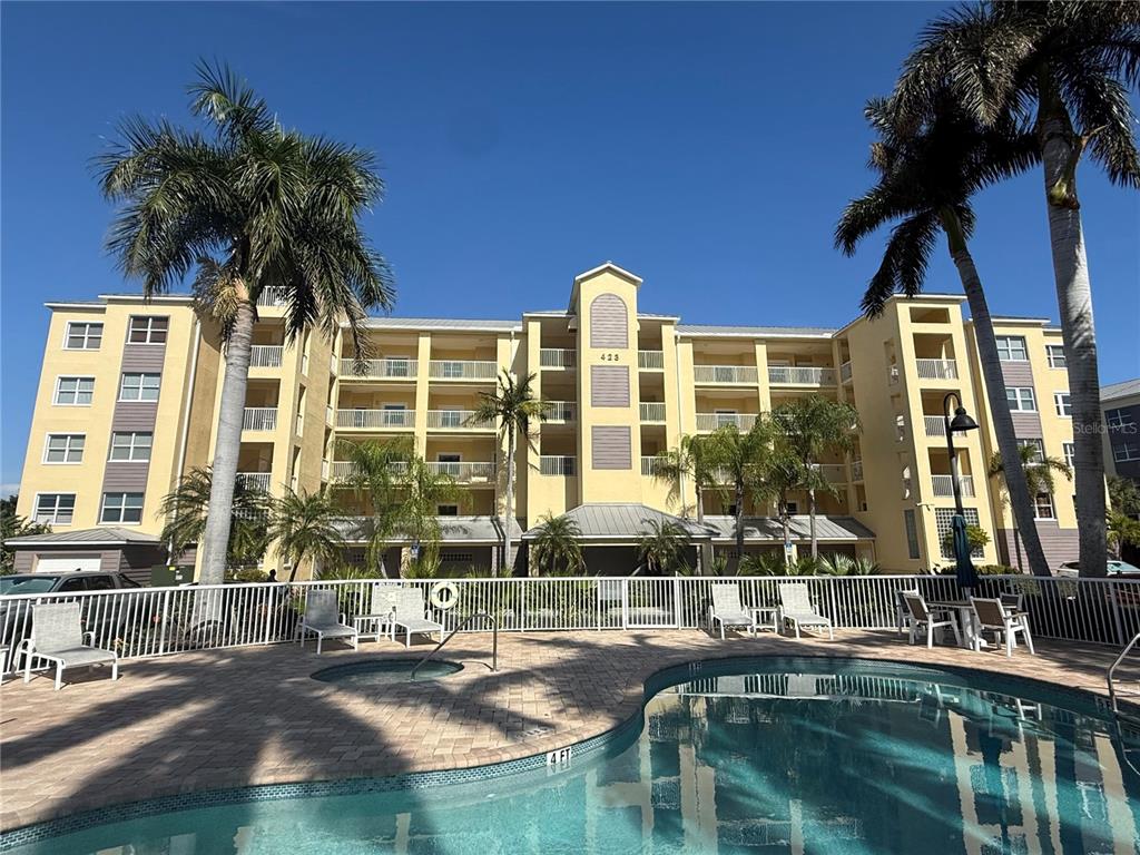 423 150th Avenue, Unit 1405 Madeira Beach, FL 33708 - Photo 1 of 23 a view of multiple houses with a yard