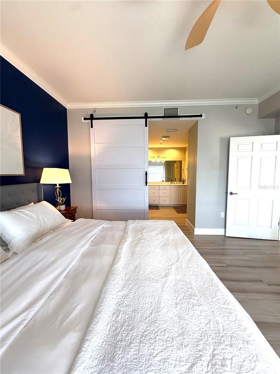 423 150th Avenue, Unit 1405 Madeira Beach, FL 33708 - Photo 13 of 23 a bedroom with a bed and a dresser