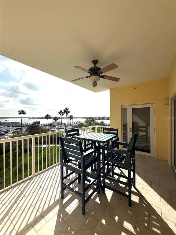423 150th Avenue, Unit 1405 Madeira Beach, FL 33708 - Photo 17 of 23 a view of a roof deck dining table and chairs