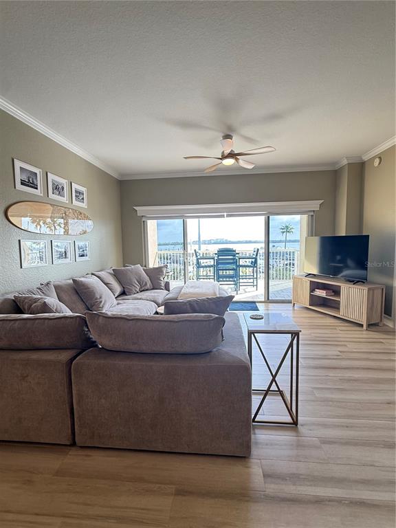 423 150th Avenue, Unit 1405 Madeira Beach, FL 33708 - Photo 6 of 23 a living room with furniture and a flat screen tv