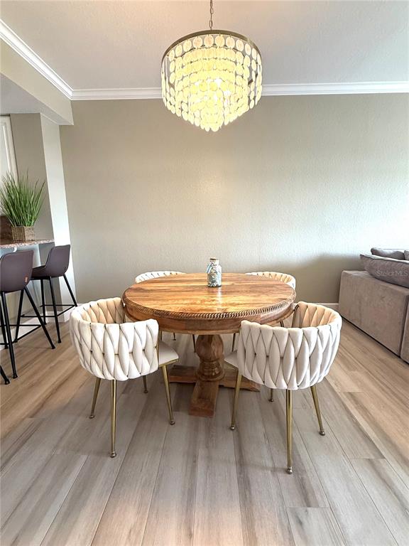 423 150th Avenue, Unit 1405 Madeira Beach, FL 33708 - Photo 9 of 23 a dining room with a table and chairs