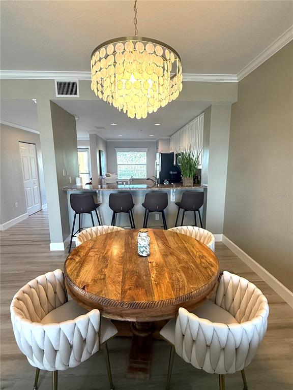 423 150th Avenue, Unit 1405 Madeira Beach, FL 33708 - Photo 10 of 23 a living room with furniture and a chandelier