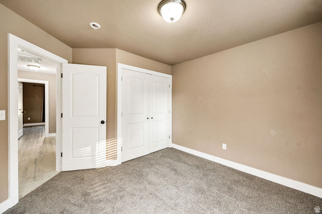 778 South 650 West Logan, UT 84321 - Photo 14 of 26 Bdrm 1 Carpeted room featuring neutral wall tones, white trim, and a double-door closet with black hardware