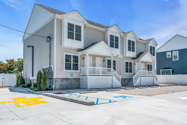 a view of a white house with swimming pool in front of it