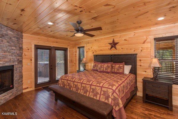 1857 Pinestand Rdg Way Pigeon Forge, TN 37862 - Photo 21 of 49 a bedroom with a bed and a fireplace