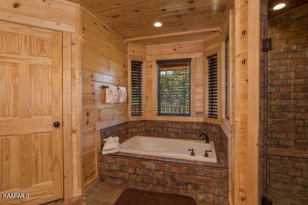 1857 Pinestand Rdg Way Pigeon Forge, TN 37862 - Photo 22 of 49 a bathroom with a tub and shower