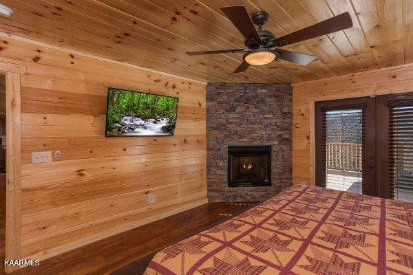 1857 Pinestand Rdg Way Pigeon Forge, TN 37862 - Photo 23 of 49 a bedroom with a bed and a fireplace