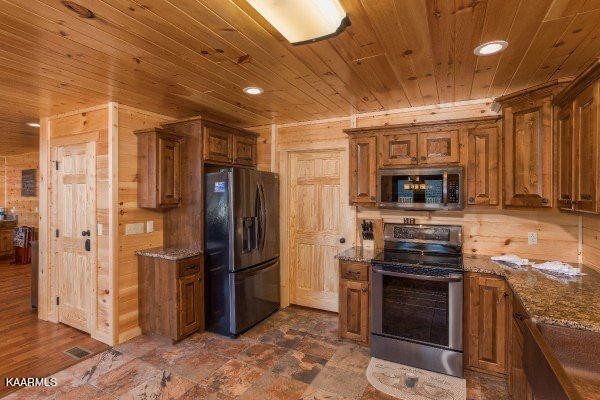 1857 Pinestand Rdg Way Pigeon Forge, TN 37862 - Photo 8 of 49 a kitchen with stainless steel appliances granite countertop a refrigerator and a stove