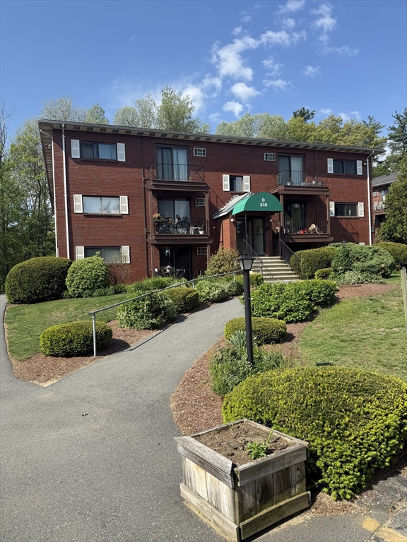 310 Codman Hill Road, Unit 34D Boxborough, MA 01719 - Photo 3 of 17 a view of house with a yard and potted plants