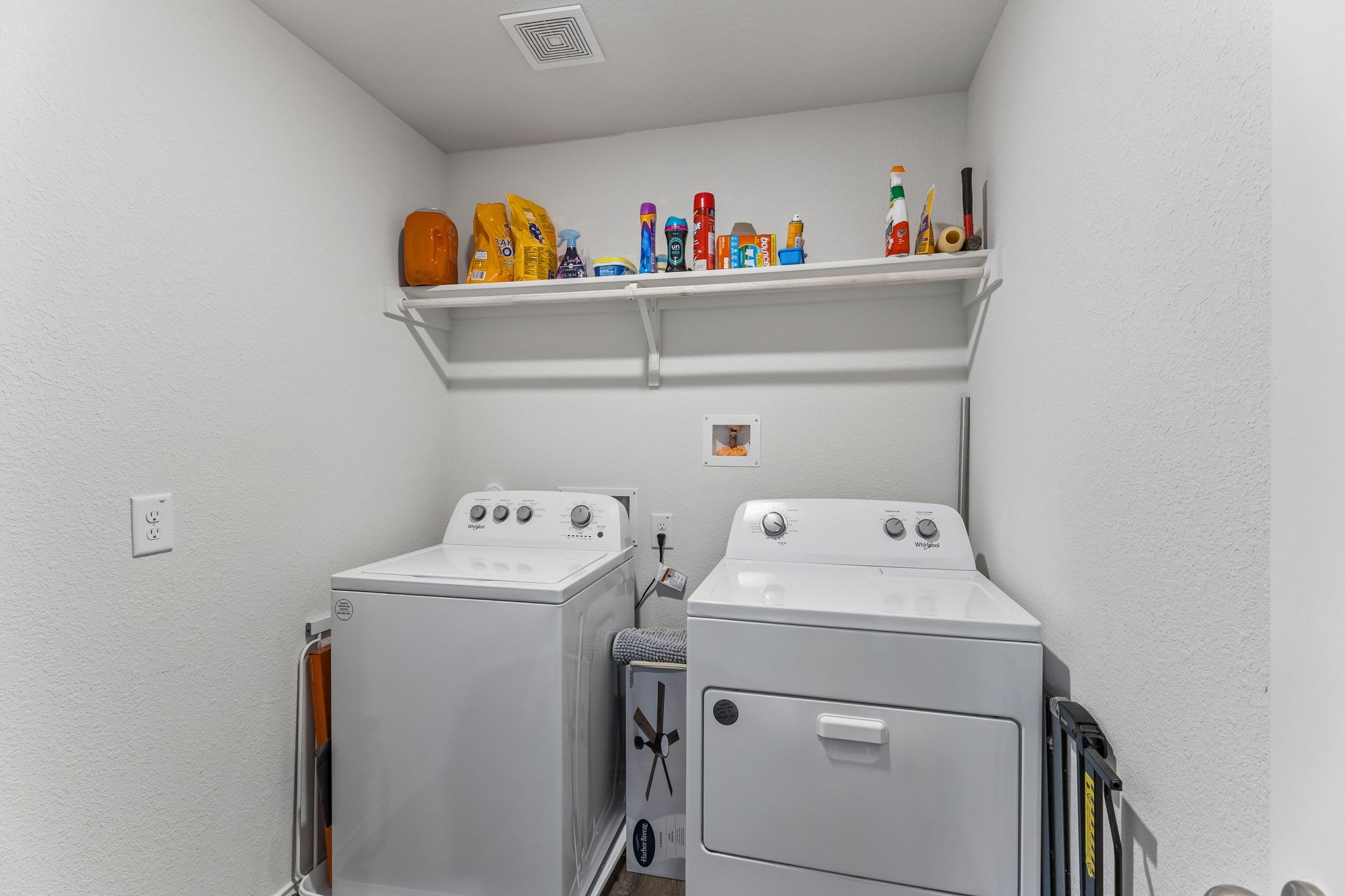 343 Sickle Loop Kyle, TX 78640 - Photo 21 of 40 Dedicated laundry space featuring a white washer and dryer, with a wall-mounted shelving unit