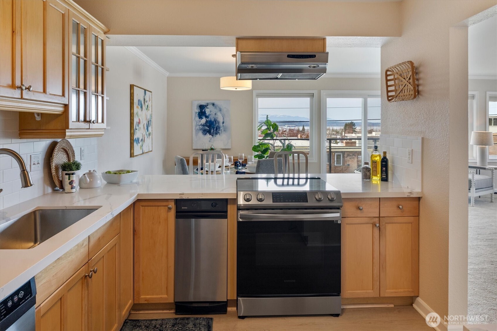 317 3rd Avenue South, Unit 201 Edmonds, WA 98020 - Photo 14 of 39 a kitchen with stainless steel appliances granite countertop a sink and cabinets