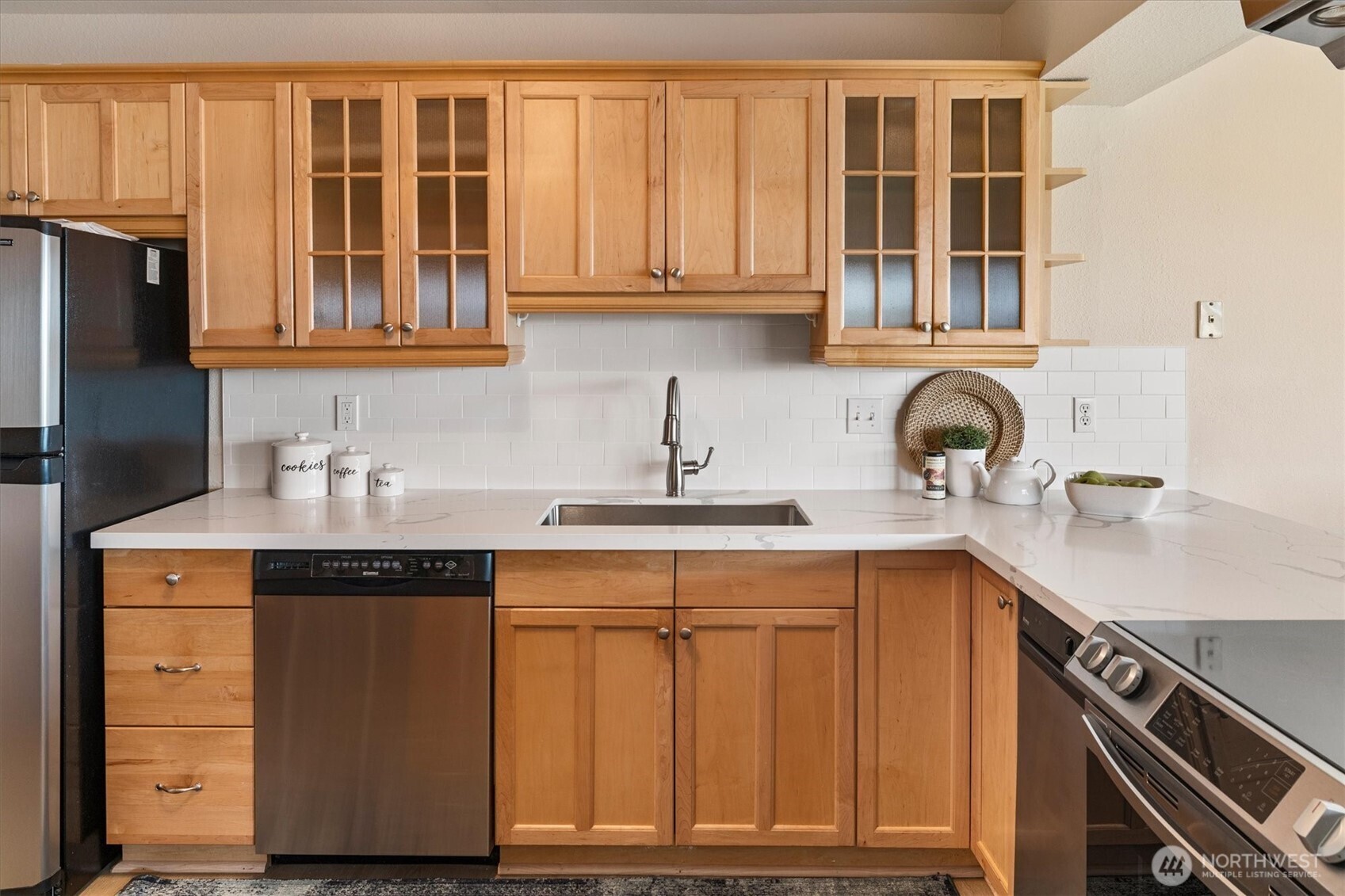 317 3rd Avenue South, Unit 201 Edmonds, WA 98020 - Photo 15 of 39 a kitchen with stainless steel appliances granite countertop a sink and cabinets