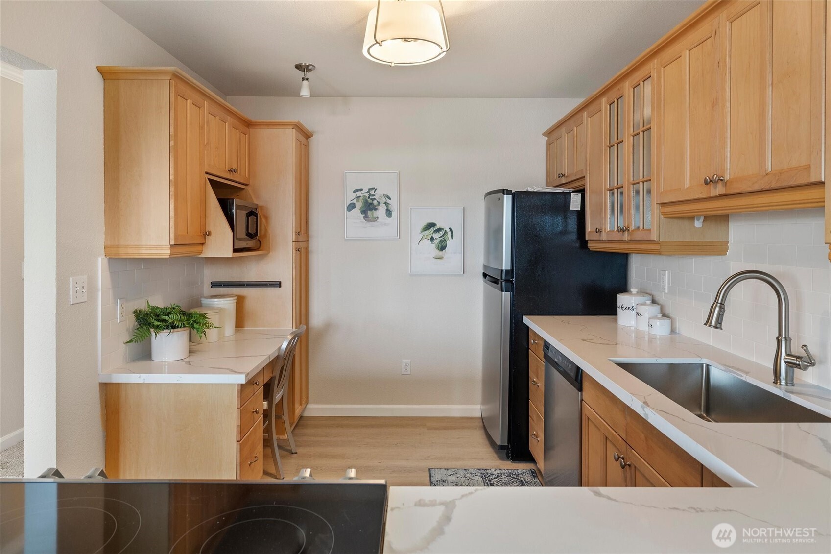 317 3rd Avenue South, Unit 201 Edmonds, WA 98020 - Photo 16 of 39 a kitchen with stainless steel appliances granite countertop a sink refrigerator and microwave