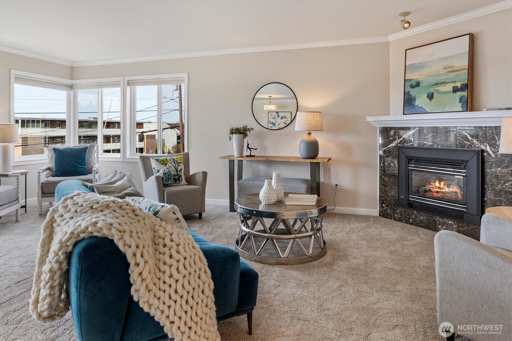 317 3rd Avenue South, Unit 201 Edmonds, WA 98020 - Photo 3 of 39 a living room with furniture a fireplace a clock and a large window
