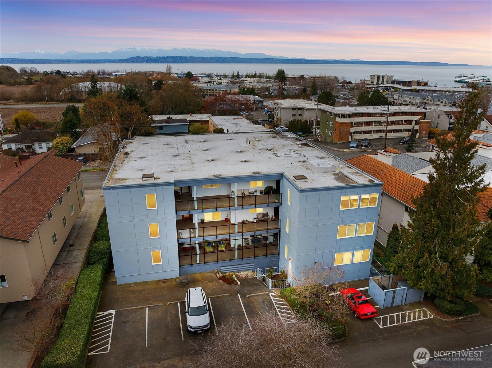 317 3rd Avenue South, Unit 201 Edmonds, WA 98020 - Photo 33 of 39 an aerial view of a house with a yard garage and lake view in back