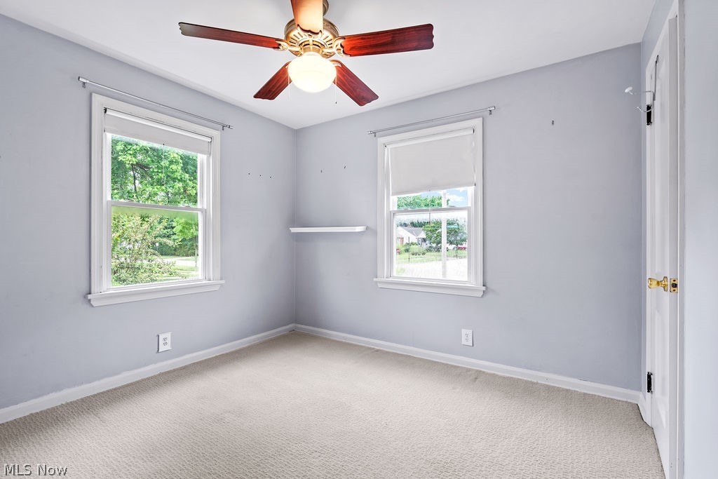 1653 Overbrook Road Cleveland, OH 44124 - Photo 5 of 29 Empty room with ceiling fan, a healthy amount of sunlight, and light colored carpet
