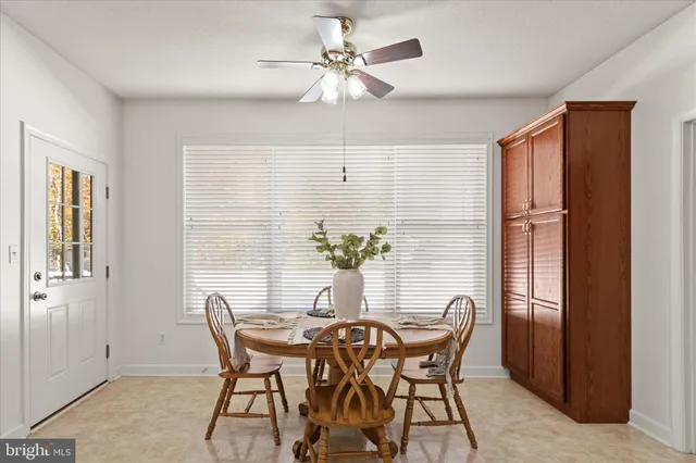 a dining room with furniture and window