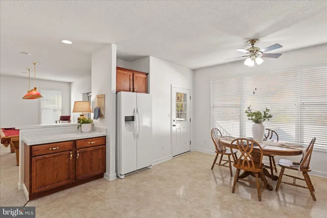 a view of a dining room with furniture and chandelier