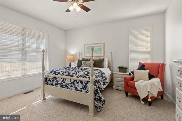 a bed room with a bed and a chair