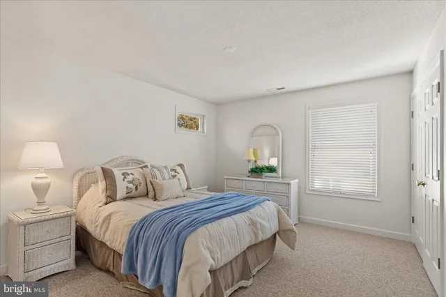 a bedroom with a bed and a lamp