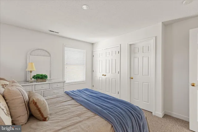 a bathroom with a sink vanity mirror and toilet